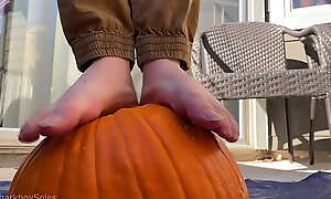 Boy bare feet smashes pumpkin and plays with it
